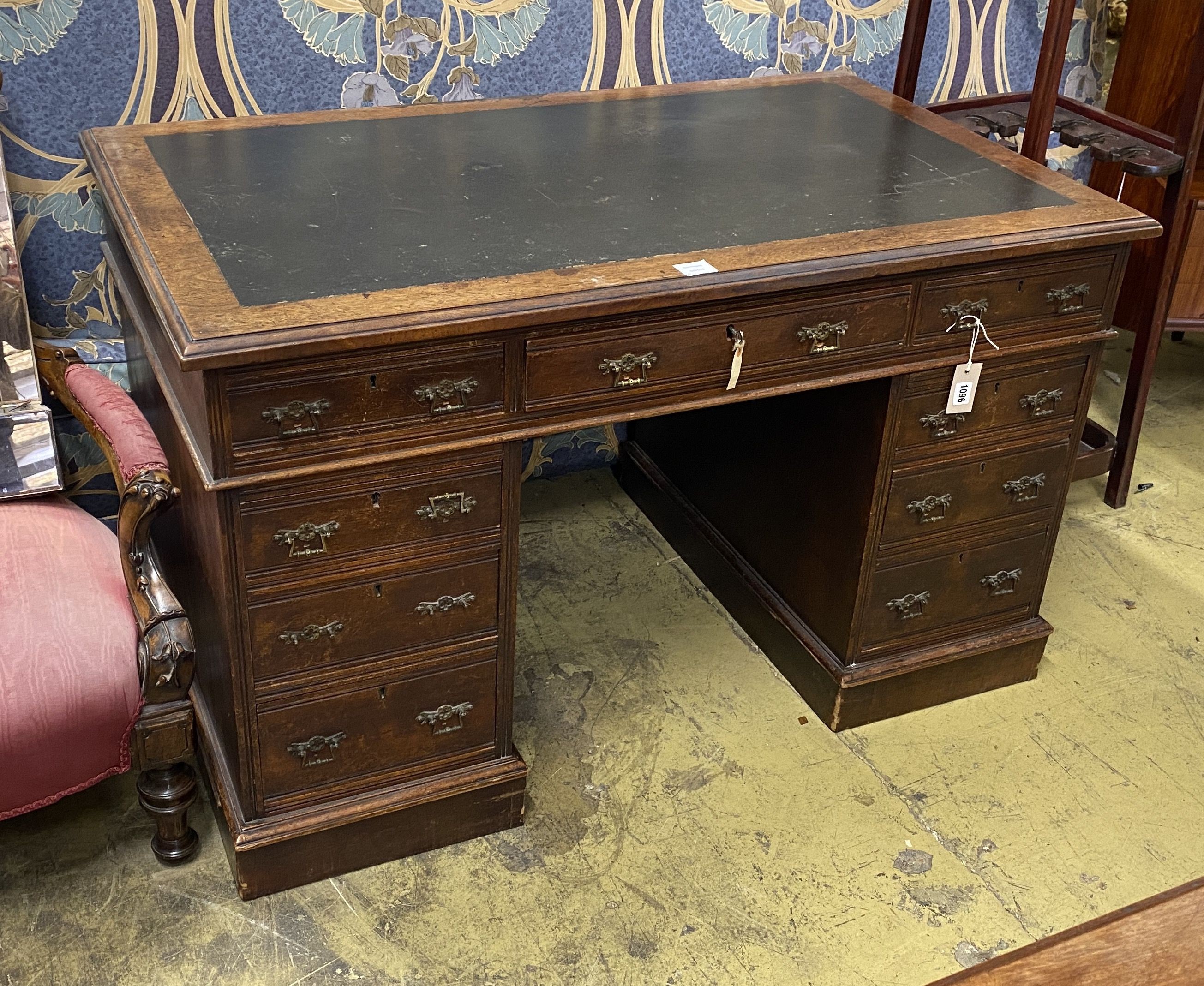 A late Victorian walnut nine drawer pedestal desk, length 122cm, depth 73cm, height 75cm